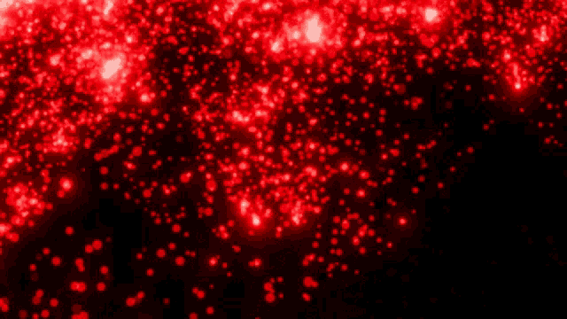 a bunch of red lights are flying in the air