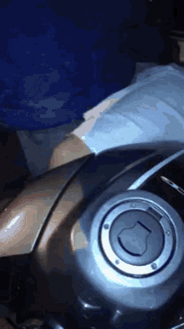 a close up of a person 's hand on a motorcycle fuel tank