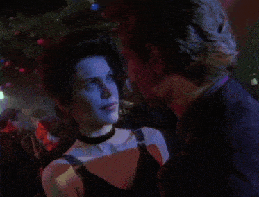 a man and woman are dancing in a dark room
