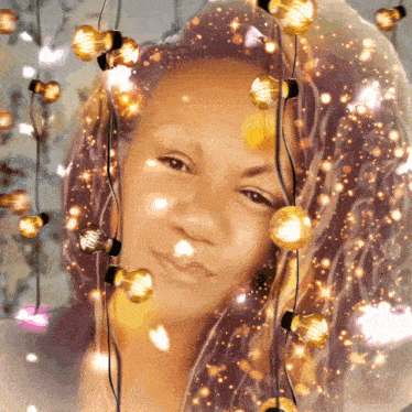 a woman is surrounded by christmas lights and a veil