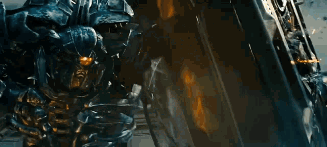 a robot is fighting another robot with a laser beam coming out of it .