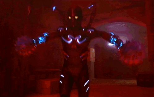 a person in a futuristic suit is holding a glowing object in their hand
