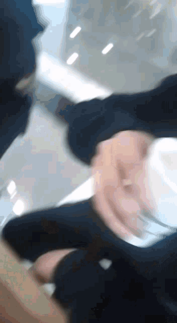a blurry photo of a person holding a cup of coffee
