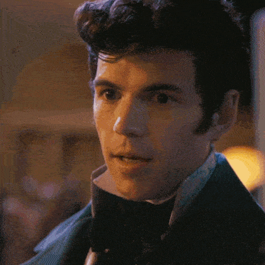 a close up of a man 's face wearing a suit and bow tie