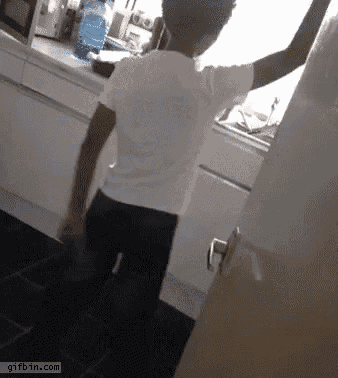 a person standing in a kitchen with a gifbin.com watermark on the bottom