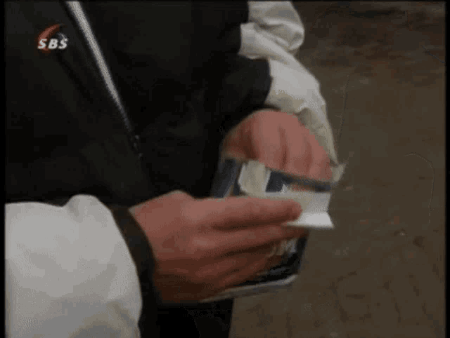 a person holding a box of jim beam cigarettes