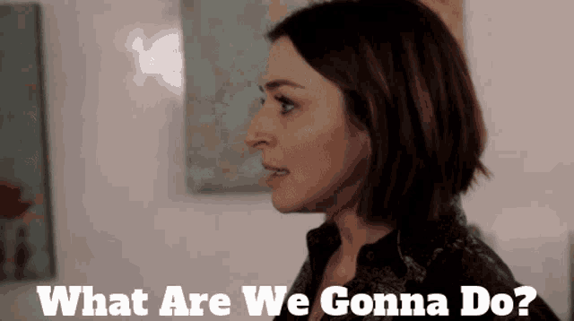 a woman says what are we gonna do in front of some paintings