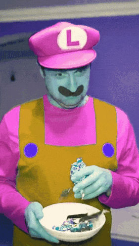 a man in a mario costume with a l on his hat
