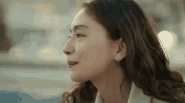 a close up of a woman 's face with her eyes closed and her mouth open .