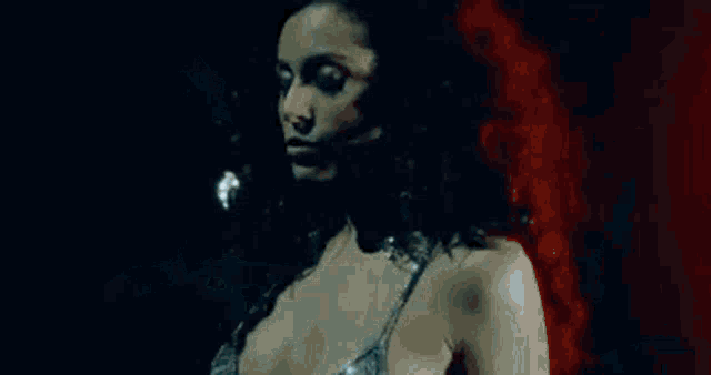 a woman in a white dress is floating in the water .