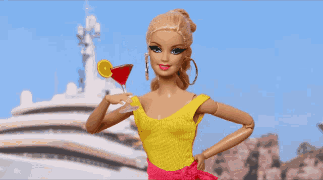 a barbie doll is holding a martini in front of a large boat