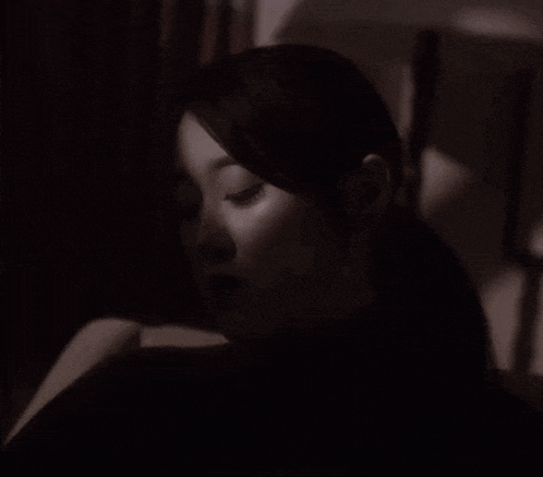 a black and white photo of a woman in a ponytail