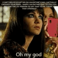 a woman is taking a picture of herself on valentine 's day while another woman looks on .