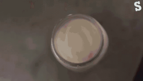 a mason jar with a doughnut on top of it