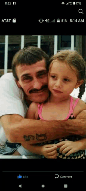 a man with a mustache is holding a little girl in his arms