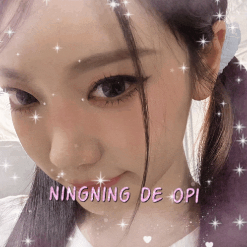 a close up of a woman 's face with the words ningning de opi written on it