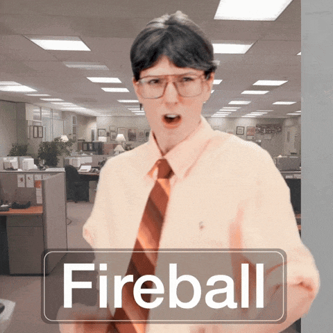 a man wearing glasses and a tie is standing in an office with a sign that says fireball