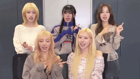 a group of girls are posing for a picture and one of them is wearing a jacket that says xie