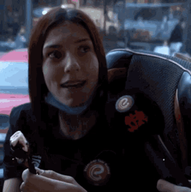 a woman wearing a mask and a black shirt with a button that says ' istanbul ' on it