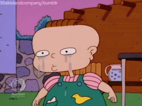 a cartoon character from rugrats is crying with tears running down his face .