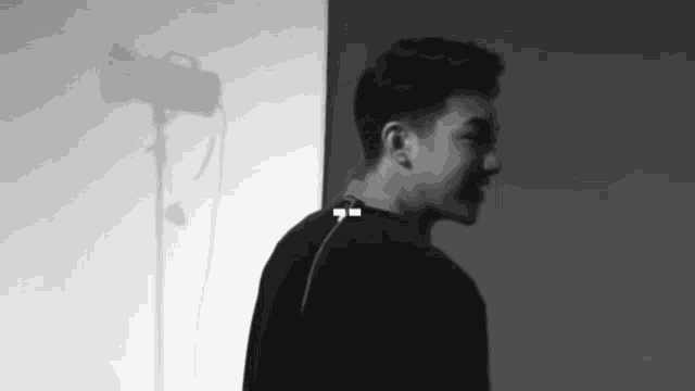 a black and white photo of a man wearing headphones