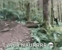 a man is walking through a muddy forest with a skull on the ground .