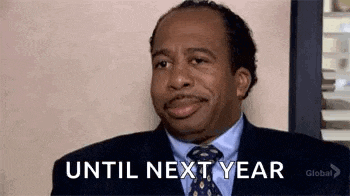 a man in a suit and tie is making a funny face and saying `` until next year '' .