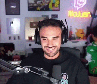 a man wearing headphones is sitting in front of a microphone in a room .