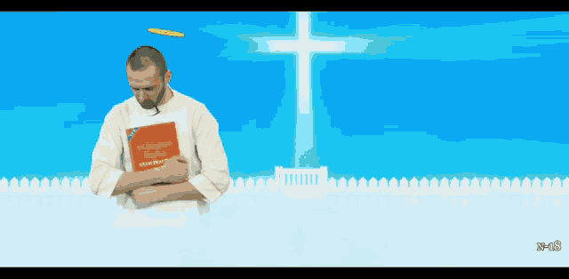 a man is holding a book that says " a catholic prayer "