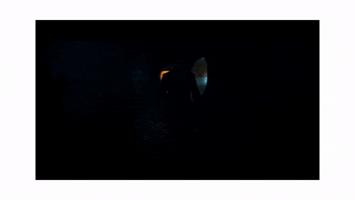 a man in a suit and tie is standing in a tunnel