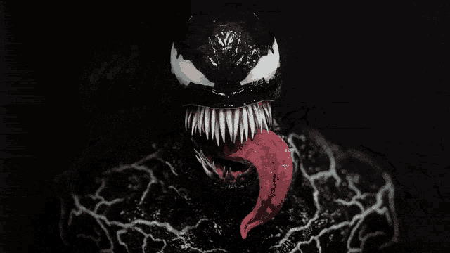 a close up of venom 's mouth with a red tongue sticking out of it
