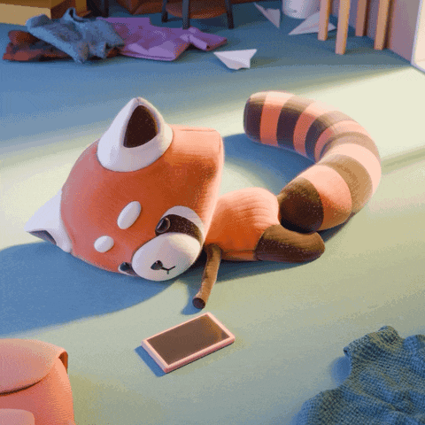 a stuffed animal is laying on the floor next to a phone
