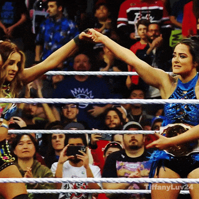 two women wrestling in a ring with a tiffany luv24 logo on the bottom