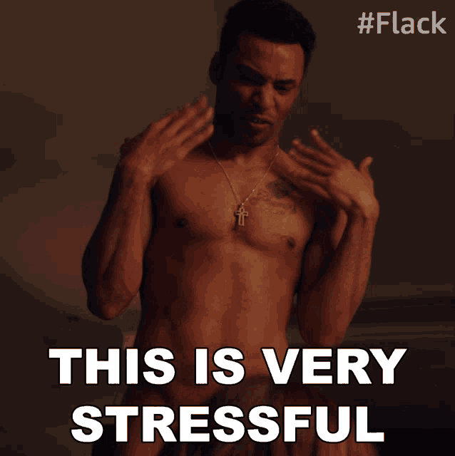 a shirtless man says this is very stressful in front of a cross