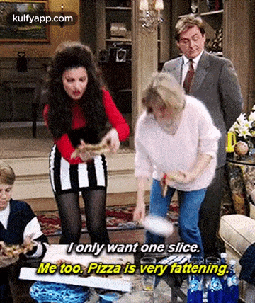 a woman is throwing a pizza in the air while another woman holds a slice of pizza .