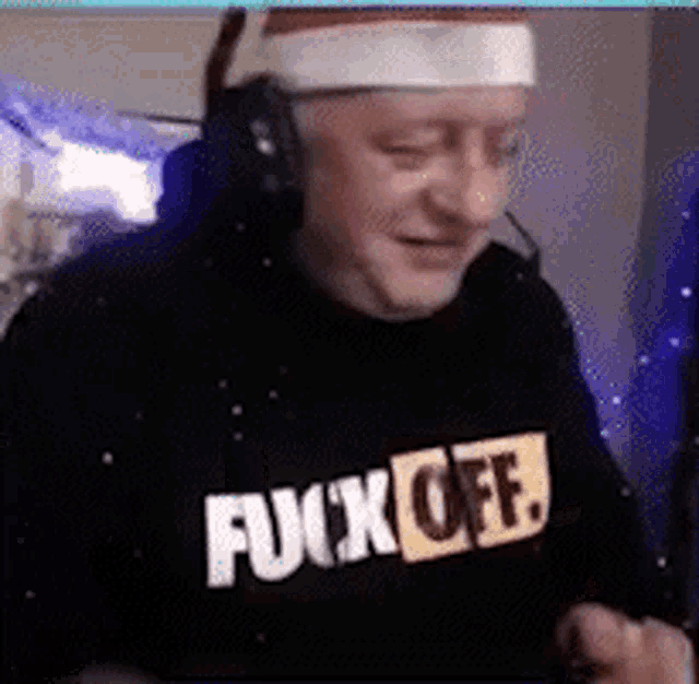 a man wearing headphones and a t-shirt that says fuck off