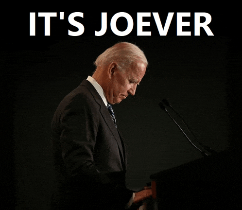 a man in a suit stands at a podium with the words " it 's joever " above him