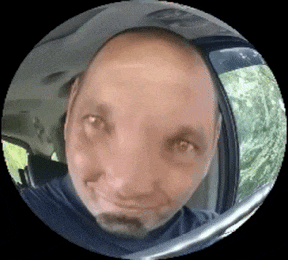 a man is taking a selfie in a car with a fisheye lens