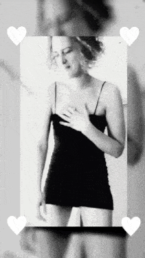 a black and white photo of a woman in a black dress surrounded by white hearts