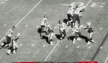 a group of football players are on a field playing a game of football .