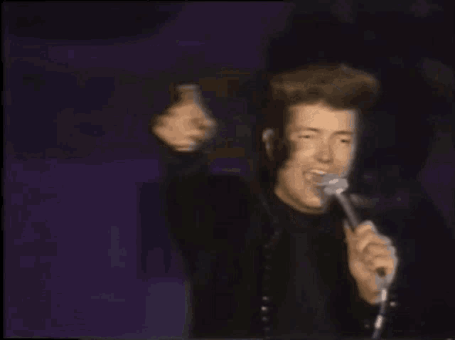 a blurry picture of a man pointing at the camera