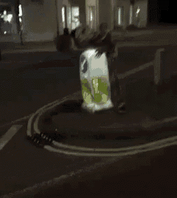 a blurry picture of a person standing on a street at night .