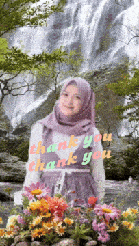 a woman in a hijab stands in front of a waterfall and flowers with the words thank you thank you written above her