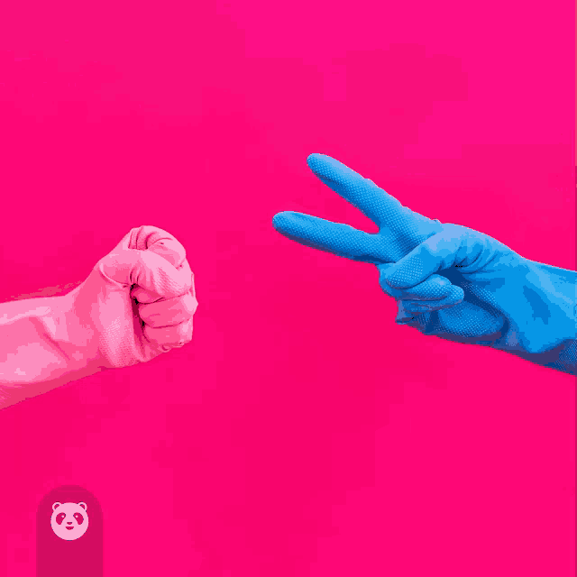 a pink fist is being thrown at a blue hand that is wearing blue gloves