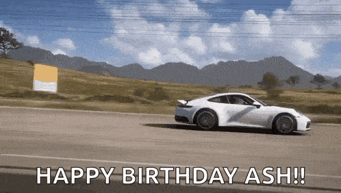 a white sports car is driving down a road with the words happy birthday ash written on it