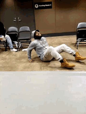 a person is doing a trick in front of a meeting room sign