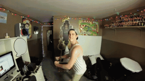 a man in a room with a sign that says toms