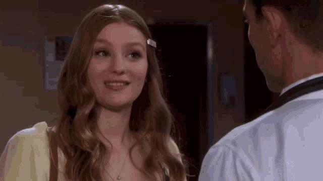 a man and a woman are looking at each other