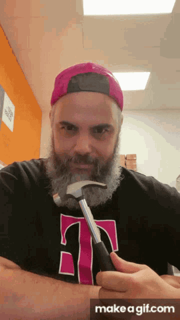 a man with a beard is wearing a t-mobile shirt