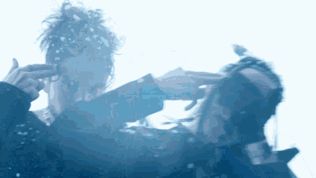 a blurry picture of a person with snow falling on their face